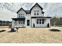 Stunning new construction home with a painted brick exterior and craftsman-style accents at 55 Firefly Ln, Louisburg, NC 27549