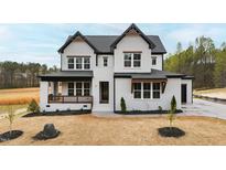 New construction home with white brick, black trim, covered porch and tasteful landscaping at 55 Firefly Ln, Louisburg, NC 27549