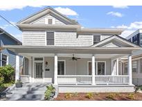 Inviting gray two-story home with a charming front porch and classic white columns at 215 E Cabarrus St, Raleigh, NC 27601