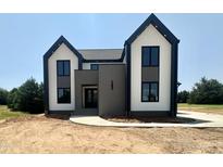 Modern two story home featuring a contrasting color palette and landscaped front yard at 280 Forest Bridge Rd, Franklinton, NC 27525