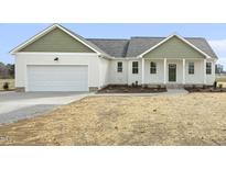 Charming single-Gathering home featuring a two-car garage and inviting green front door at 233 Surles Rd, Benson, NC 27504