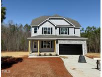Charming two-story home with gray siding, black shutters, and an attached two-car garage at 40 Sunrise Ct, Spring Hope, NC 27882