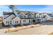 New townhome development showcasing modern farmhouse exteriors and landscaping at 3929 Willow Gate Way, Raleigh, NC 27604