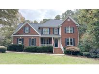 Two-story brick home with landscaped lawn and porch at 159 Trantham Trl, Clayton, NC 27527