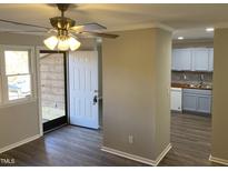Bright entryway with wood floors and view into updated kitchen at 501 Kendall Dr, Durham, NC 27703
