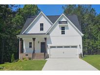 Charming two-story home featuring a two-car garage, covered porch, and well-manicured lawn at 698 Magnolia Acres Ln, Fuquay Varina, NC 27526