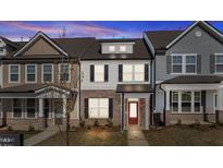 Charming two-story home with a brick facade and inviting red front door at 955 Alma Railway Dr # 563, Wake Forest, NC 27587