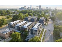 Stunning aerial view of modern townhomes with a cityscape backdrop, surrounded by lush greenery at 10 Seawell Ave # 105, Raleigh, NC 27601