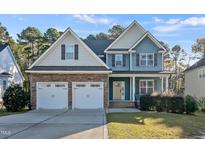 Inviting two-story home with a stone facade and attached two-car garage at 98 Valley Brook Ln, Spring Lake, NC 28390