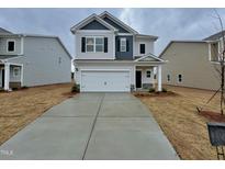Charming two-story home with a two-car garage and a well-manicured front yard at 216 Bruce Dr, Dunn, NC 28334