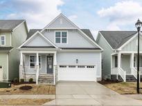 Charming home with a two-car garage, stone accents, and a welcoming front porch at 1253 Barreto Dr, Wendell, NC 27591