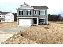 Two-story gray house with a white garage door and a small yard at 158 Citizens Ct # 32, Four Oaks, NC 27524