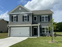 Charming two-story home with gray siding, white trim, black shutters and a two car garage at 158 Citizens Ct # 32, Four Oaks, NC 27524