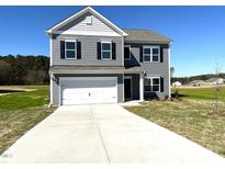 Two story home with gray siding, black shutters and a two car garage on a sunny day at 158 Citizens Ct # 32, Four Oaks, NC 27524