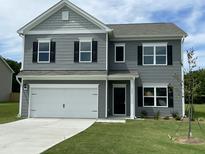 Charming two-story home featuring gray siding, black shutters, and a two-car garage on a well-maintained lawn at 158 Citizens Ct # 32, Four Oaks, NC 27524