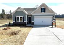 Inviting single-story home with a two-car garage, manicured lawn, and charming curb appeal at 346 Olivia Crossing Ct # 12, Four Oaks, NC 27524