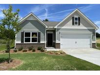 Charming single-story home featuring a manicured lawn, two-car garage, and inviting craftsman-style facade at 346 Olivia Crossing Ct # 12, Four Oaks, NC 27524