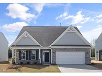 Charming single-story home featuring a stone facade, two-car garage, and well-maintained landscaping at 1232 Cricket St, Elon, NC 27244