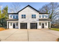 Modern duplex with white siding, black garage doors, and ample parking at 329 & 331 Roxboro St, Haw River, NC 27258