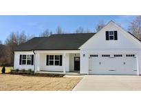 Charming white home featuring a covered porch, a two-car garage, and black shutters at 59 Mossy Bridge Ct, Lillington, NC 27546