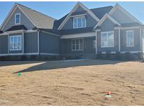 Charming home with a well-manicured lawn and inviting architectural details at 70 Water Willow Ln, Zebulon, NC 27597