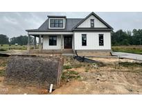 New construction white farmhouse with a brick foundation, and a covered front porch at 5124 Grist Stone Way, Youngsville, NC 27596