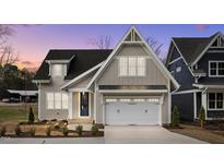 Beautiful craftsman-style home with a two-car garage and manicured front lawn at 418 S Cross St, Youngsville, NC 27596