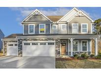 Beautiful two-story home with stone accents, attached garage, and manicured lawn at 611 Highview Dr, Benson, NC 27504