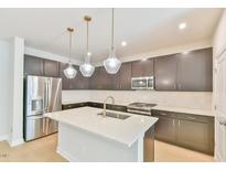 Modern kitchen features stainless steel appliances, a kitchen island, and stylish pendant lighting at 140 Norwell Ln, Pittsboro, NC 27312