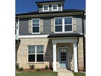 Charming two-story home with brick facade, gray siding, and a welcoming light-blue front door at 937 Alma Railway Dr # 555, Wake Forest, NC 27587