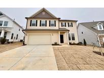 Two-story house with beige vinyl siding, brown roof, and a two-car garage at 99 Baird Cove Ln # 173, Angier, NC 27501