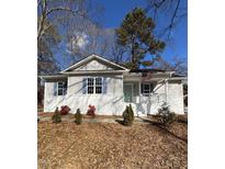 Newly renovated house with gray siding, white trim, and a teal front door at 530 Lansing St, Raleigh, NC 27610