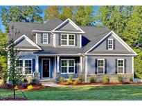 Charming two-story home with a landscaped front yard and a welcoming entryway at 1112 Armsleigh Ct, Raleigh, NC 27603