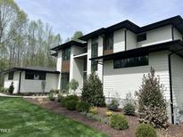 Stunning contemporary home featuring modern design and manicured landscaping at 196 Mountaintop Cir, Pittsboro, NC 27312