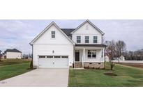 Two-story white house with a gray roof and a two-car garage at 432 Old Fashioned Way, Lillington, NC 27546