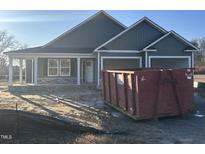 Newly constructed home with gray siding and a two-car garage at 17 Maxwell Farm Ln, Selma, NC 27576