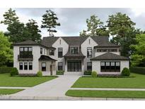 Magnificent home featuring a light brick exterior, dark-trimmed windows, complemented by mature landscaping and a concrete driveway at 216 Dartmouth Rd, Raleigh, NC 27609