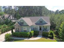 Charming home with a manicured front yard, inviting porch and brick and siding accents at 181 Colonial Ridge Dr, Pittsboro, NC 27312