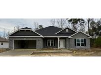 Charming new construction featuring a brick facade, attached garage, and a welcoming front entrance at 60 Falls Of The Cape Dr, Lillington, NC 27546