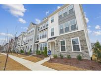 New townhome community with multiple units, stone and gray siding at 444 Billingshurst Way, Knightdale, NC 27545