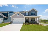 Charming two-story home features a well-manicured lawn, attached two car garage, and craftsman style architecture at 657 Sun Meadow Dr, Wake Forest, NC 27587