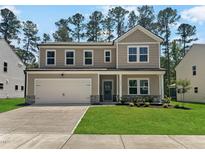 Charming two-story home featuring a two-car garage and well-manicured lawn at 1216 Dimaggio Dr # 29, Raleigh, NC 27616
