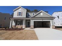 Charming two-story home with stone accents and attached two-car garage at 1221 Dimaggio Dr # 10, Raleigh, NC 27616