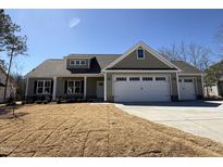 Charming single-story home featuring manicured lawn, attached two-car garage, and stylish exterior at 102 Roma Gora Ct, Princeton, NC 27569