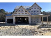 Two-story home under construction, featuring an attached two-car garage and covered porch, set against a clear sky at 106 Roma Gora Ct, Princeton, NC 27569