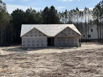 New home under construction featuring a craftsman style elevation and wooded backyard at 612 Tuscany Cir, Princeton, NC 27569