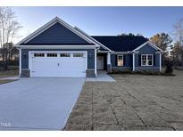 Newly constructed home with a two-car garage and stone accents at 613 Tuscany Cir, Princeton, NC 27569