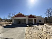 Charming single-story home with a stone-accented facade and an attached two-car garage at 702 Tuscany Cir, Princeton, NC 27569