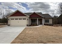 Charming single-story home with attached two-car garage and freshly laid lawn at 702 Tuscany Cir, Princeton, NC 27569