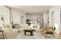 Open living room featuring a sectional sofa, wood coffee table, and kitchen island view at 1304 Shearwater Way, Knightdale, NC 27545